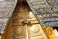 MECCA, SAUDI ARABIA: The golden doors of the Holy Kaaba closeup, covered with Kiswah. Massive lock on the doors. Entrance to the Kaaba in Masjid al Haram