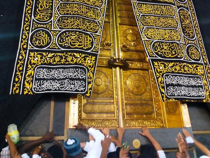 MECCA, SAUDI ARABIA - March 2019: The golden doors of the Holy Kaaba closeup, covered with Kiswah. Massive lock on the doors. Entrance to the Kaaba in Masjid al Haram