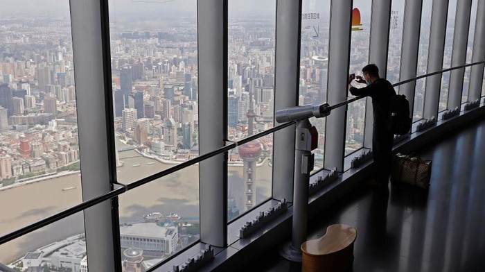 SHANGHAI, CHINA - JULY 01: A tourist enjoys view from 