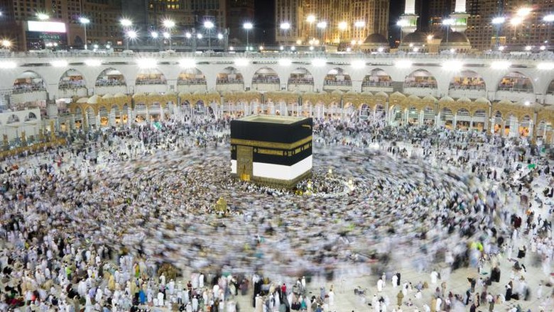 624699610 Muslim pilgrims, from all around the World, revolving around the Kaaba at night during Hajj in Saudi Arabia