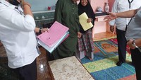 AB dan istri terlihat senyum-senyum saat dijemput polisi di rumahnya. (dok. Humas Polda Lampung)