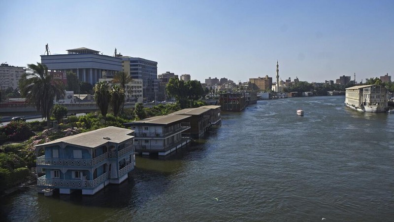The houseboat belonging to Ikhlas Helmy is seen from the other side of the River Nile on June 27, 2022. A government push to remove the string of houseboats from Cairo’s Nile banks has dwindled their numbers from a several dozen to just a handful. Helmy stands to evicted, and the boat moved or demolished. The tradition of living on the Nile River dates back to the 1800s, and the removal of the boats has drawn criticism in Egypt. The government says it plans to develop the waterfront.   (AP Photo/Tarek Wagih)
