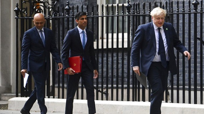 From left, British Health Secretary Sajid Javid, Chancellor of the Exchequer Rishi Sunak and Prime Minister Boris Johnson arrive at No 9 Downing Street for a media briefing on May 7, 2021. Two of Britain’s most senior Cabinet ministers have quit, a move that could spell the end of Prime Minister Boris Johnson’s leadership after months of scandals. Treasury chief Rishi Sunak and Health Secretary Sajid Javid resigned within minutes of each other. (Toby Melville/PA via AP)