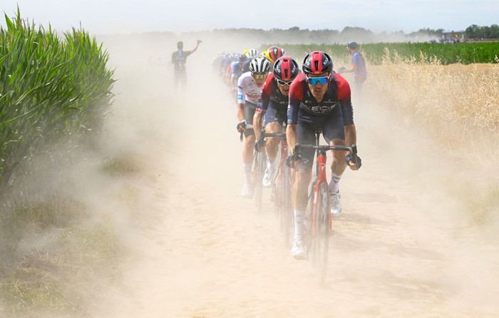 1241736412 UAE Team Emirates team's Slovenian rider Tadej Pogacar (3rd R) wearing the best young rider's white jersey, Ineos Grenadiers team's British rider Geraint Thomas (2nd R) and Ineos Grenadiers team's Dutch rider Dylan Van Baarle (R) cycle across a cobblestone sector in the final kilometers of the 5th stage of the 109th edition of the Tour de France cycling race, 153,7 km between Lille and Arenberg Porte du Hainaut, in northern France, on July 6, 2022. (Photo by Bernard PAPON / POOL / AFP) (Photo by BERNARD PAPON/POOL/AFP via Getty Images)
