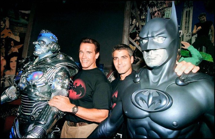 BEVERLY HILLS, UNITED STATES:  The stars of the film Batman & Robin, actors Arnold Schwarzenegger (L) and George Clooney (R) pose with their costumes Mr. Freeze and Batman 06 June at Planet Hollywood in Beverly Hills, where the costumes will be on permanent display.  Schwarzenegger, who plays Mr Freeze, recently had heart surgery. (Photo credit should read MIKE NELSON/AFP via Getty Images)