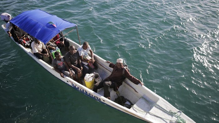 Perubahan Iklim Bikin Nelayan Kenya Susah Dapat Tuna Fishermen swim out from an incoming boat at a berth, some with their overnight catch in Kwale county, Gazi Bay, Kenya on Sunday, June 12, 2022. Artisanal fisheries on Kenya's coast say climate change, overfishing by large foreign vessels and a lack of other job opportunities for coastal communities is draining the Indian Ocean of its yellowfin tuna stocks. (AP Photo/Brian Inganga)