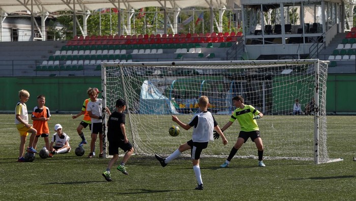 Young players of the Olymp football club attend a training session at the Central stadium in the Irpin town, which was heavily damaged during Russia's invasion of Ukraine, outside of Kyiv, Ukraine July 6, 2022. REUTERS/Valentyn Ogirenko