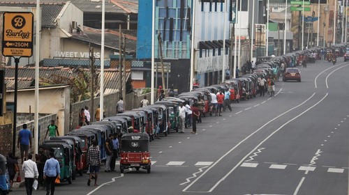 Air Force members stand guard at a Lanka IOC fuel station (Indian Oil Corporation) as people queue up to buy fuel due to fuel shortage, amid the countrys economic crisis, in Colombo, Sri Lanka, July 6, 2022. REUTERS/Dinuka Liyanawatte