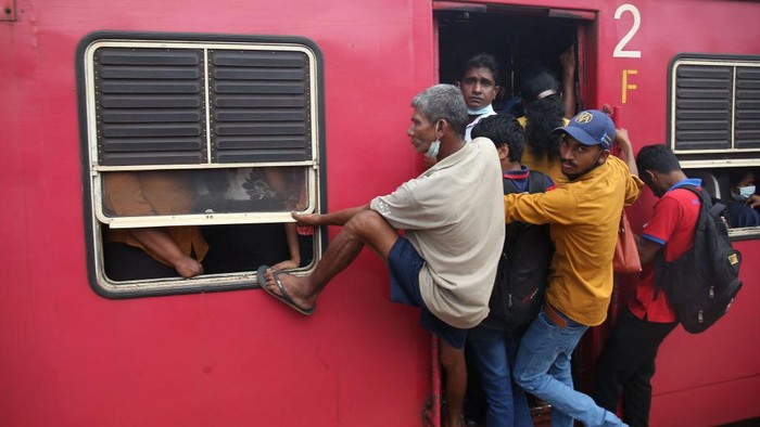 Passengers board the engine compartment of an overcrowded train in Colombo, Sri Lanka. On July 6, 2022. Other public transport in Sri Lanka has been disrupted due to a huge fuel shortage amid the country's economic crisis(Photo by Pradeep Dambarage/NurPhoto via Getty Images)