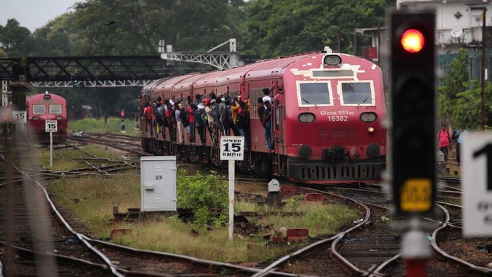 Passengers board the engine compartment of an overcrowded train in Colombo, Sri Lanka. On July 6, 2022. Other public transport in Sri Lanka has been disrupted due to a huge fuel shortage amid the country's economic crisis(Photo by Pradeep Dambarage/NurPhoto via Getty Images)