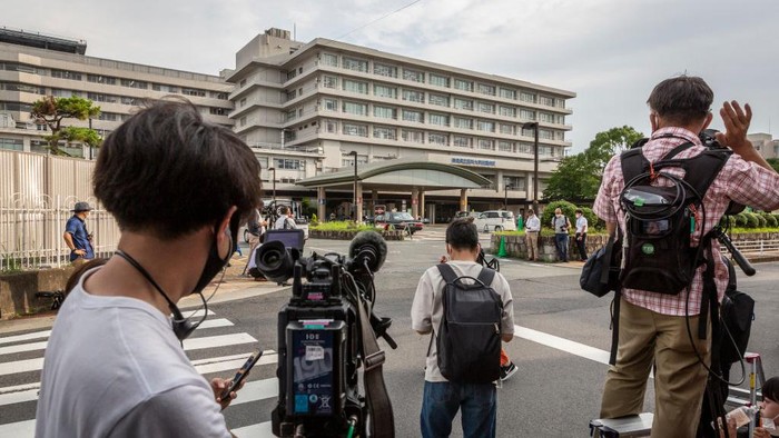 NARA, JAPAN - JULY 09: People cycle past Nara Medical University Hospital where Japan’s former prime minister Shinzo Abe is transferred after being attacked during an election campaign on July 09, 2022 in Nara, Japan. Former Prime Minister Abe collapsed after shots were heard while he was campaigning at a rally. A suspect was apprehended and taken into custody, as Abe was rushed to a hospital via helicopter. (Photo by Yuichi Yamazaki/Getty Images)