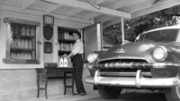 Layanan drive thru tahun 1957 di Florida, Amerika Serikat ini unik! Terlihat seorang wanita menjual susu sapi segar yang bisa dibeli langsung dari mobil. Foto: ranker.com / Jude Newsome