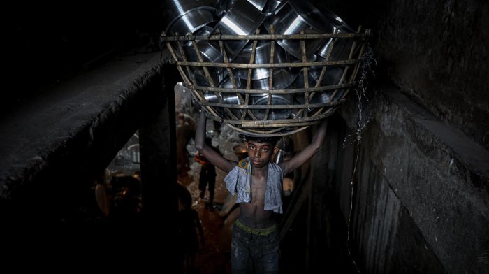 A child works inside a kitchen utensils factory at Shyampur in Dhaka, Bangladesh on July 4, 2022. (Photo by Kazi Salahuddin Razu/NurPhoto via Getty Images)