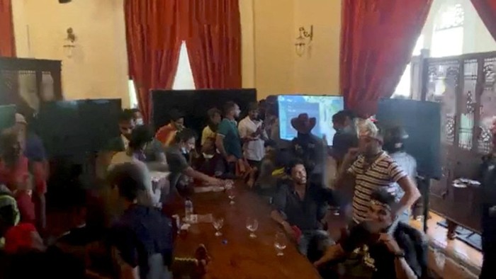 A demonstrator speaks during a protest inside the Presidents House, after President Gotabaya Rajapaksa fled, amid the countrys economic crisis, in Colombo, Sri Lanka, in this screengrab obtained from social media video on July 9, 2022. News Cutter via REUTERS ATTENTION EDITORS - THIS IMAGE HAS BEEN SUPPLIED BY A THIRD PARTY. MANDATORY CREDIT. NO RESALES. NO ARCHIVES.