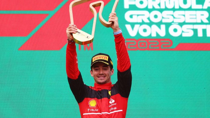 SPIELBERG, AUSTRIA - JULY 10: Race winner Charles Leclerc of Monaco and Ferrari celebrates on the podium during the F1 Grand Prix of Austria at Red Bull Ring on July 10, 2022 in Spielberg, Austria. (Photo by Clive Rose/Getty Images)
