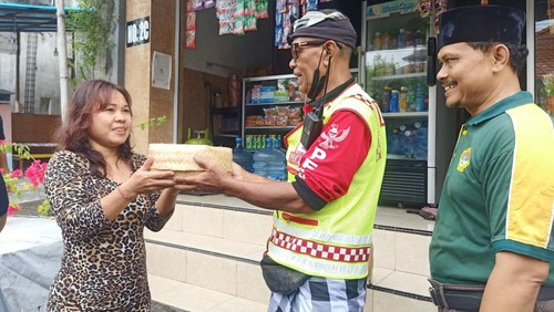 Pihak LDII Bali bersama dengan Pecalang ketika ngejot daging kurban kepada warga lintas agama yang berada di kawasan LDII Bali, di Jalan Padang Griya II No 1 Denpasar, Bali pada Minggu (10/7/2022).