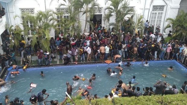 Anti government protesters swim in a pool at the president's official residence after storming into it in Colombo, Sri Lanka, Saturday July 9, 2022. (AP Photo/STR)