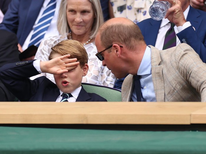 LONDON, ENGLAND - JULY 10: Prince William, Duke of Cambridge (R) and Prince George of Cambridge interact in the Royal Box watching Novak Djokovic of Serbia play Nick Kyrgios of Australia during their Mens Singles Final match on day fourteen of The Championships Wimbledon 2022 at All England Lawn Tennis and Croquet Club on July 10, 2022 in London, England. (Photo by Ryan Pierse/Getty Images)
