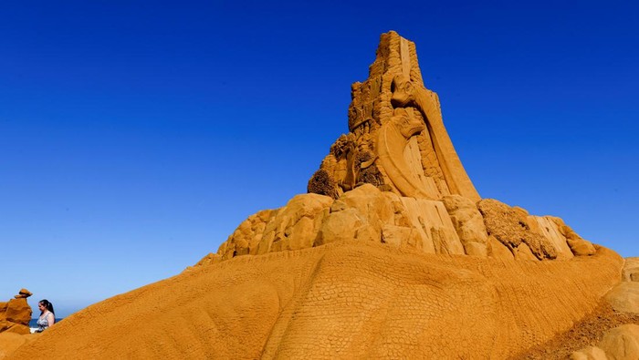 BELGIUM-ART/SAND SCULPTURES A visitor walks between sculptures during the Sand Sculpture Festival