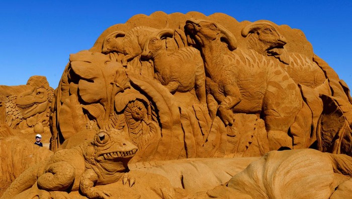 BELGIUM-ART/SAND SCULPTURES A visitor walks between sculptures during the Sand Sculpture Festival
