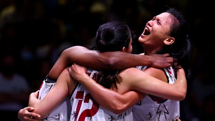 SINGAPORE, SINGAPORE - JULY 10: Dyah Lestari #1 (R) of Indonesia celebrates with her teammates after defeating Japan in their womens bronze medal game during the FIBA 3x3 Asia Cup at Marina Bay Sands on July 10, 2022 in Singapore. (Photo by Yong Teck Lim/Getty Images)