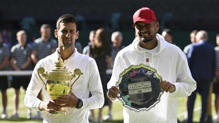 Tennis - Wimbledon - All England Lawn Tennis and Croquet Club, London, Britain - July 10, 2022 Serbia's Novak Djokovic celebrates with the trophy on the balcony after winning the men's singles final against Australia's Nick Kyrgios REUTERS/Toby Melville