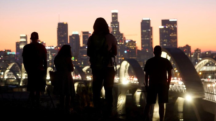 LOS ANGELES, CALIFORNIA - JULY 11: People take in a view of the newly-opened 6th Street Viaduct, connecting Boyle Heights with downtown L.A., on July 11, 2022 in Los Angeles, California. The $588-million project which opened over the weekend took six years to finish and is designed to withstand a magnitude 9.0 earthquake. The original viaduct was constructed in 1932 and demolished in 2016 after it was determined to be seismically-deficient.  (Photo by Mario Tama/Getty Images)