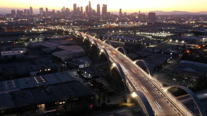 LOS ANGELES, CALIFORNIA - JULY 11: People take in a view of the newly-opened 6th Street Viaduct, connecting Boyle Heights with downtown L.A., on July 11, 2022 in Los Angeles, California. The $588-million project which opened over the weekend took six years to finish and is designed to withstand a magnitude 9.0 earthquake. The original viaduct was constructed in 1932 and demolished in 2016 after it was determined to be seismically-deficient. (Photo by Mario Tama/Getty Images)