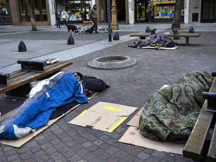 Homeless sleep on a sidewalk in downtown Buenos Aires, Argentina, on a cold, early Friday, July 8, 2022. Four of every 10 Argentines are poor and inflation is more than 60% in the past 12 months. (AP Photo/Rodrigo Abd)