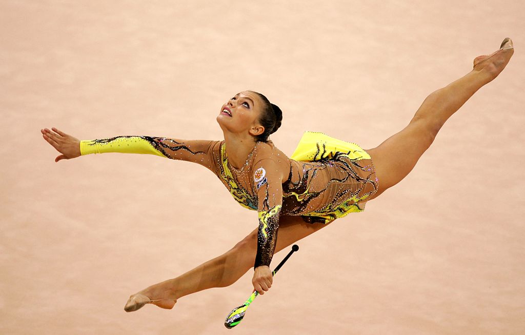 Alina Kabaeva of Russia performs the clubs during the individual all-round final of the gymnastics rythmic at the Galatsi Olympic hall in Athens, 29 August 2004 during the Olympic Games. Kabaeva won the gold before fellow Russian Irina Tchachina and Anna Bessonova of Ukraine on third. AFP PHOTO / ODD ANDERSEN (Photo by Odd ANDERSEN / AFP) (Photo by ODD ANDERSEN/AFP via Getty Images)