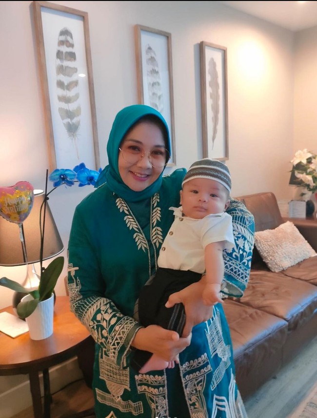 Rayakan Idul Adha bersama sang nenek, Yora Febrina, begini penampilan keduanya. Sambil digendong, baby Izz tampak begitu nyaman dalam dekapan ibunda Nikita Willy itu. Foto: Instagram/@yorafebrina