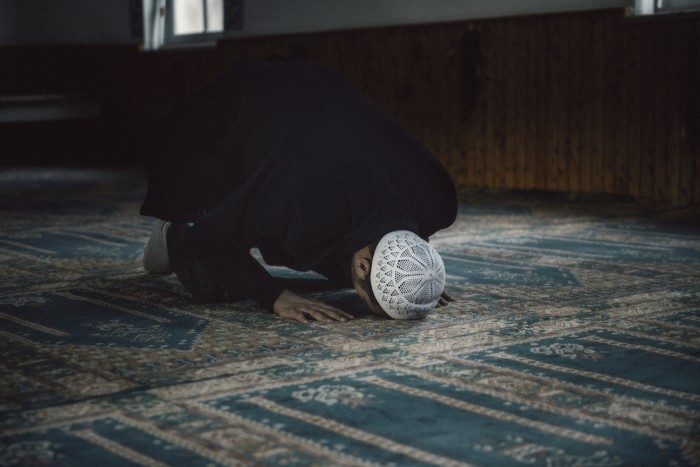 Shot of a Muslim young man worshiping in a mosque.