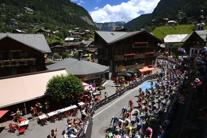 MEGEVE, FRANCE - JULY 12: A general view of the peloton passing through Morzine while fans cheer prior to the 109th Tour de France 2022, Stage 10 a 148,1km stage from Morzine to Megève 1435m / #TDF2022 / #WorldTour / on July 12, 2022 in Megeve, France. (Photo by Alex Broadway/Getty Images)
