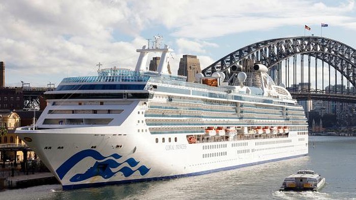 SYDNEY, AUSTRALIA - JULY 13: The Coral Princess docks at Circular Quay on July 13, 2022 in Sydney, Australia. The Coral Princess, currently experiencing a COVID-19 outbreak on board, arrived in Sydney on Wednesday morning. (Photo by Jenny Evans/Getty Images)