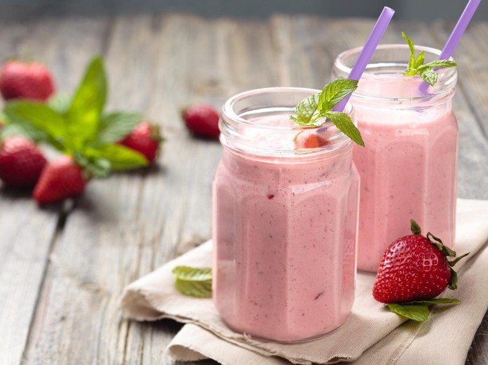 Fruit smoothie with mint leaves on wooden rustik table