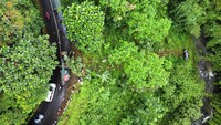 Alat berat dikerahkan untuk mengevakuasi mobil wisatawan yang terperosok ke dalam jurang tersebut.