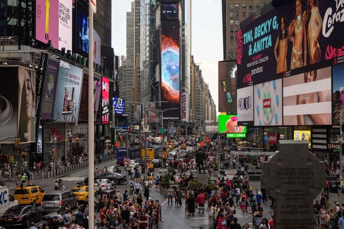 A person takes a video of the gians screens displaying images captured by The James Webb Space Telescope in Times Square on July 12, 2022 in New York. - Released one by one starting from 10:30 am Eastern (1430 GMT) at the Goddard Space Flight Center, the new images demonstrated the full power of the $10 billion observatory, which uses infrared cameras to gaze into the distant universe with unprecedented clarity. (Photo by Yuki IWAMURA / AFP) (Photo by YUKI IWAMURA/AFP via Getty Images)