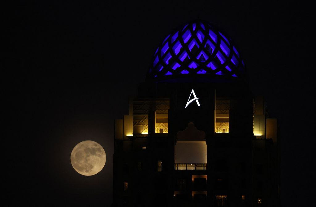 The full 'Buck' super moon, rises behind the Dubai Marina in the Gulf emirate of Dubai, on July 13, 2022. (Photo by GIUSEPPE CACACE / AFP) (Photo by GIUSEPPE CACACE/AFP via Getty Images)
