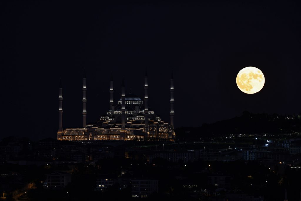  Super moon rises over Grand Camlica Mosque in Istanbul, Turkiye on July 13, 2022. (Photo by Ali Atmaca/Anadolu Agency via Getty Images)