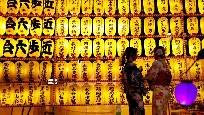 Women in yukata, or casual summer kimonos, wearing protective masks amid the coronavirus disease (COVID-19) outbreak, look around lanterns during the annual Mitama Festival at the Yasukuni Shrine, where more than 2.4 million war dead are enshrined, in Tokyo, Japan, July 13, 2022. REUTERS/Kim Kyung-Hoon TPX IMAGES OF THE DAY
