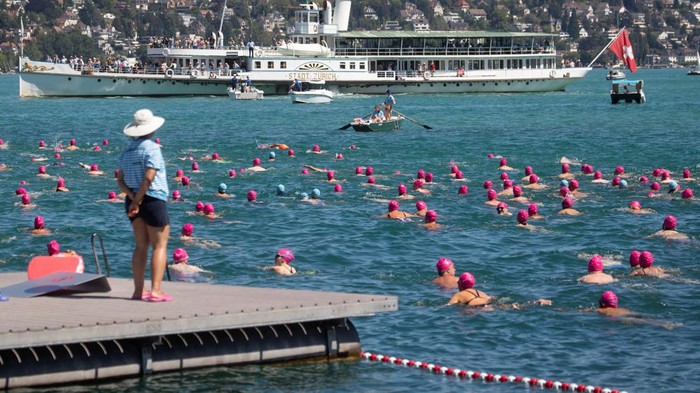 Tourist ship Stadt Zurich sails past as people take part in the annual public Lake Zurich crossing swimming event in Zurich, Switzerland July 13, 2022. REUTERS/Arnd Wiegmann