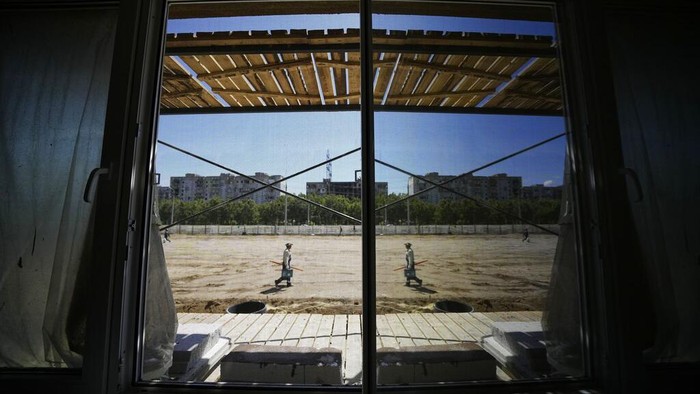 Construction workers work on the site of a new apartment building which is building with support of Russia Defense Ministry in Mariupol, on the territory which is under the Government of the Donetsk People's Republic control, eastern Ukraine, Wednesday, July 13, 2022. This photo was taken during a trip organized by the Russian Ministry of Defense. (AP Photo)