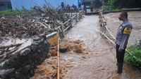 Seorang petugas melihat sampah yang menyumbat Sungai Dawe di Desa Golantepus, Mejobo, Kudus, Jawa Tengah, Kamis (14/7/2022).