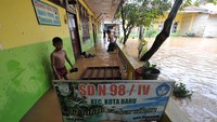 Sekolah yang terendam banjir menghentikan kegiatan belajar mengajar.