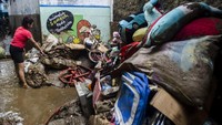 Warga menumpuk barang dan perabotan yang terendam lumpur akibat banjir bandang Sungai Cimanuk di Garut, Jawa Barat.