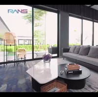Dan di sebelah kiri lift, terdapat ruang televisi yang menyatu dengan kitchen bar. Seluruh furnitur bernuansa abu-abu. Meskipun terletak di tengah kota, rumah berlantai tiga itu memiliki pemandangan danau. Foto: dok. YouTube Rans Entertainment