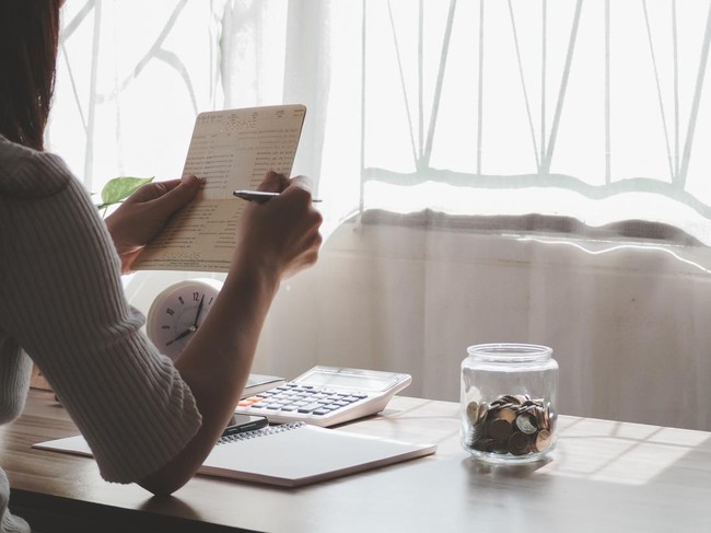 Women hands holding saving account passbook. financial report passbook saving money finance and business rich concept. financial problems, unemployment due to pandemic covid-19.