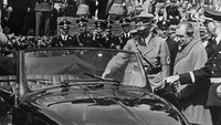 Hitler terlihat meninjau sebuah VW ditemani Ferdinand Porsche di Fallersleben, Jerman, Mei 1938, 