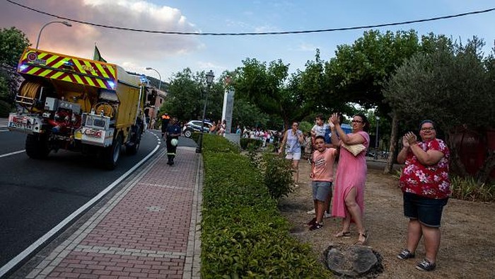 Apresiasi Warga Untuk Para Pejuang Pemadam Kebakaran Hutan di Spanyol AVILA, SPAIN - JULY 18: Residents applaud firefighters as they pass by as a forest fire approaches their municipality at El Hoyo de Pinares on July 18, 2022 in Avila, Spain. Wildfires have broken out across Spain and southern Europe amid a severe heatwave. (Photo by Pablo Blazquez Dominguez/Getty Images)