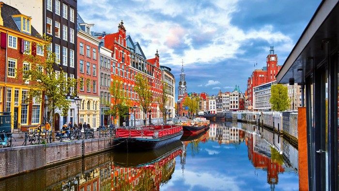 Channel in Amsterdam Netherlands houses river Amstel landmark old european city spring landscape.